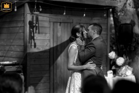 Rosemont, Quebec, Canada: Bride and groom share their first kiss during their backyard home wedding ceremony.